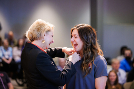 photo of nursing student receiving their nursing pin at the graduating Pinning ceremony