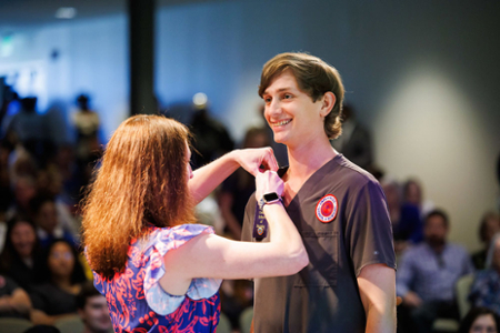 photo of nursing student receiving their nursing pin at the graduating Pinning ceremony