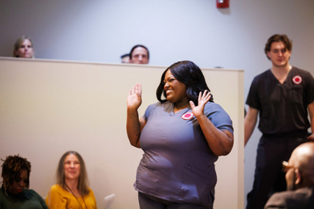 photo of nursing student celebrating as her name is called during her Pinning ceremony