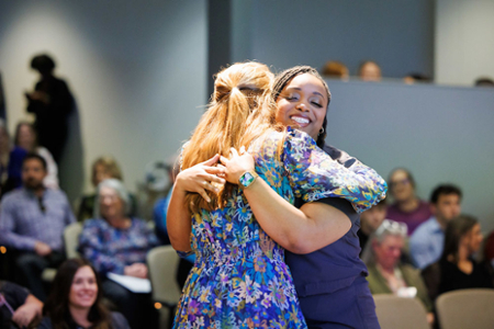 nursing student receiving a hug from her faculty member after being pinned during her Pinning ceremony