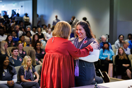 photo of nursing student receiving their nursing pin at the graduating Pinning ceremony