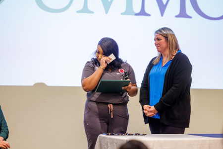nursing student showing emotion while her nomination is being read during a DAISY Student Nurse Award presentation